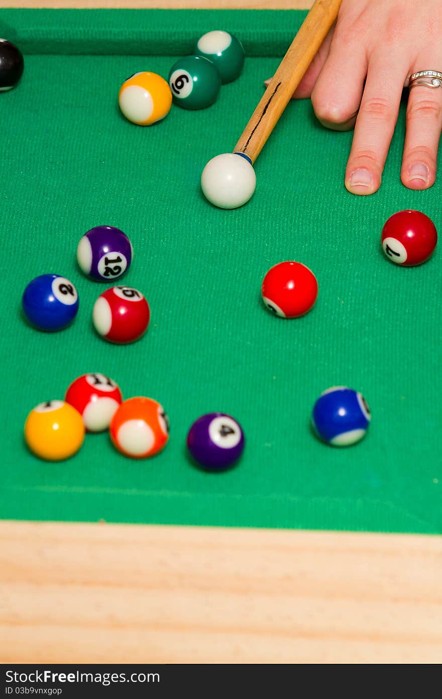 Green billiard (poool) table with bunch of balls