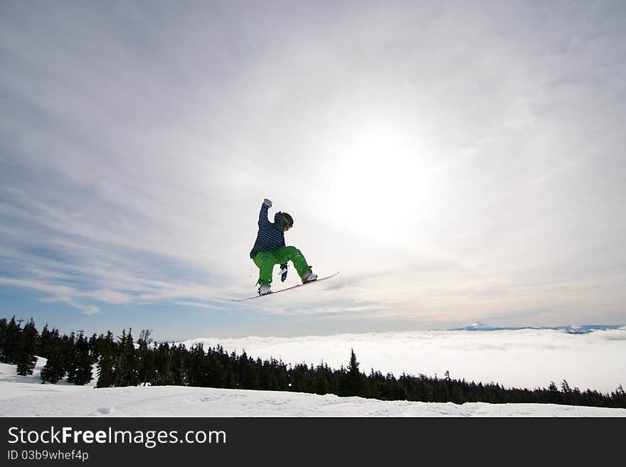 Male Snowboarder Catches Big Air.