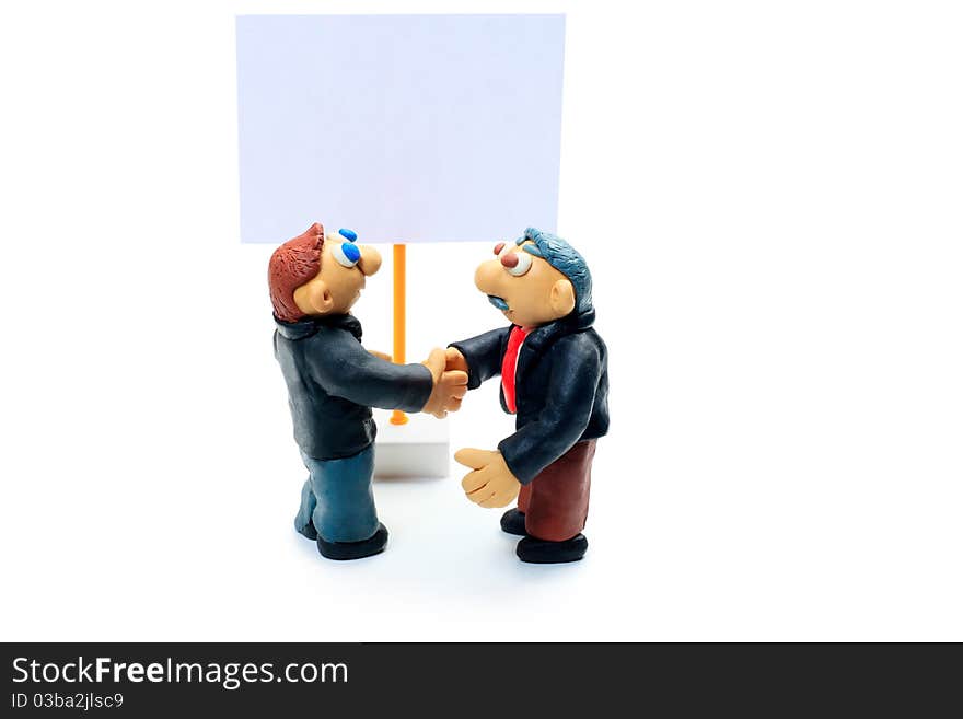 Shot of two plasticine businessmen shaking their hands. Isolated over white background. Shot of two plasticine businessmen shaking their hands. Isolated over white background.