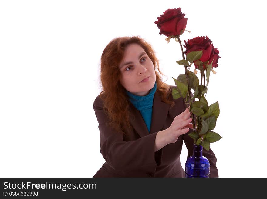 A young woman is arranging flowers in a vase. A young woman is arranging flowers in a vase