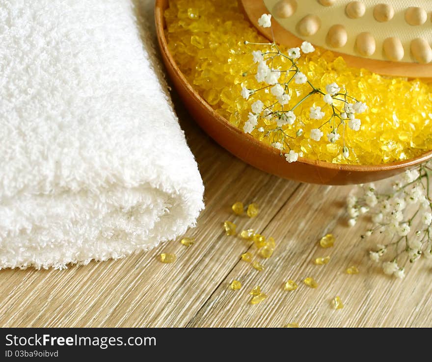 Spa composition of yellow bath salts and towel. Spa composition of yellow bath salts and towel