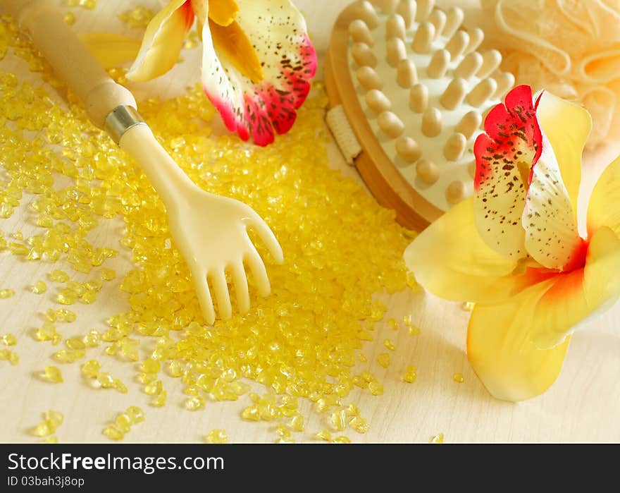 Spa composition on yellow bath salt and flowers