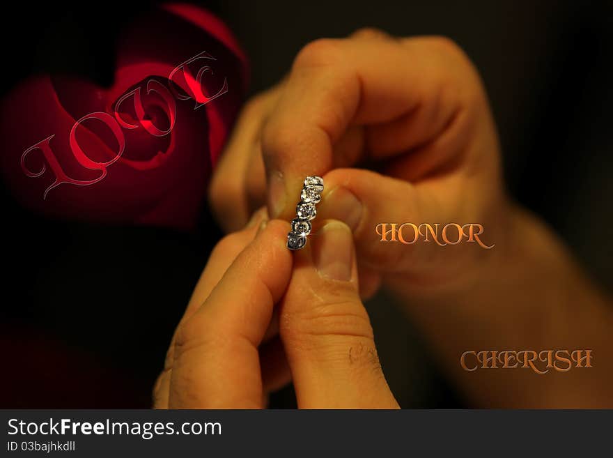 A gentleman holding an engagement ring with a single red rose in the background and the words love cherish and honor. A gentleman holding an engagement ring with a single red rose in the background and the words love cherish and honor.