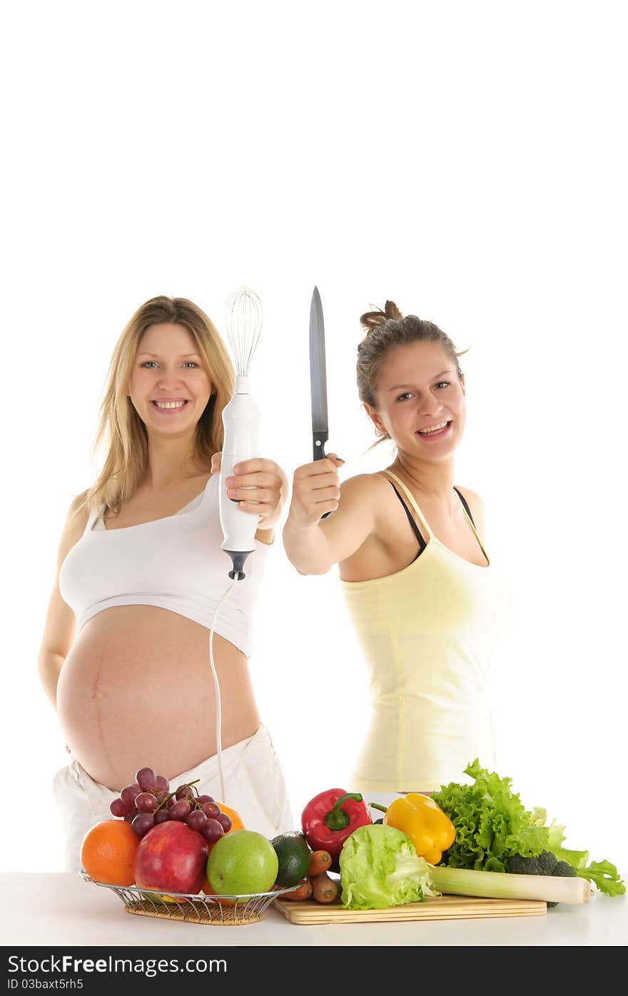 Happy woman with fruit, blender and a knife