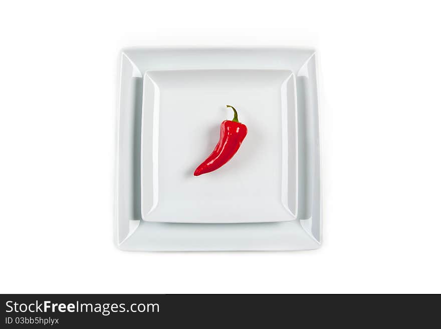 Red Pepper on a salad plate against a large white background. Red Pepper on a salad plate against a large white background