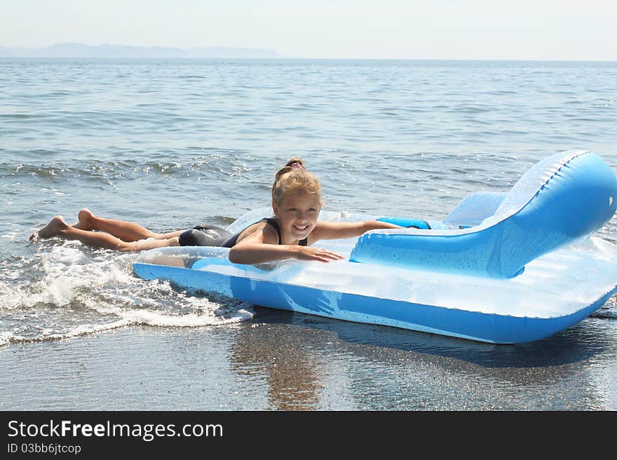 Girl of seven years on  inflatable mattress in  sea. Girl of seven years on  inflatable mattress in  sea