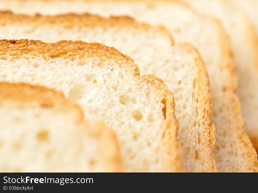 Row of slices of wheaten bread, closeup. Row of slices of wheaten bread, closeup