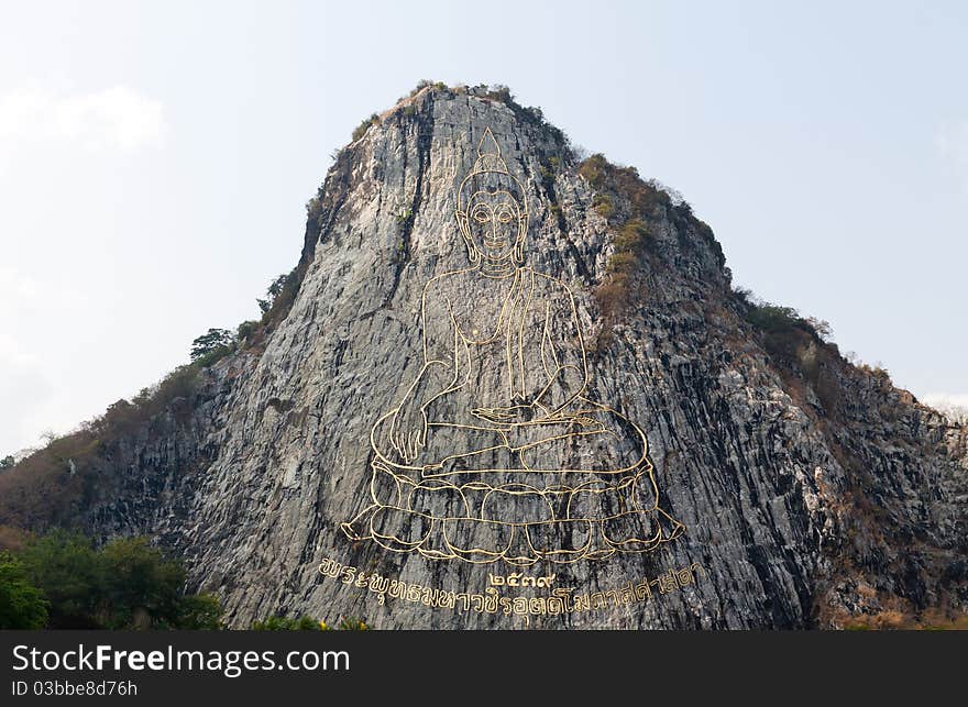 Gold Painting Of Buddha Statue On Cliff