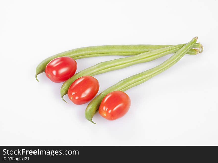 Red cherry tomatoes with French beans clipping path. Red cherry tomatoes with French beans clipping path