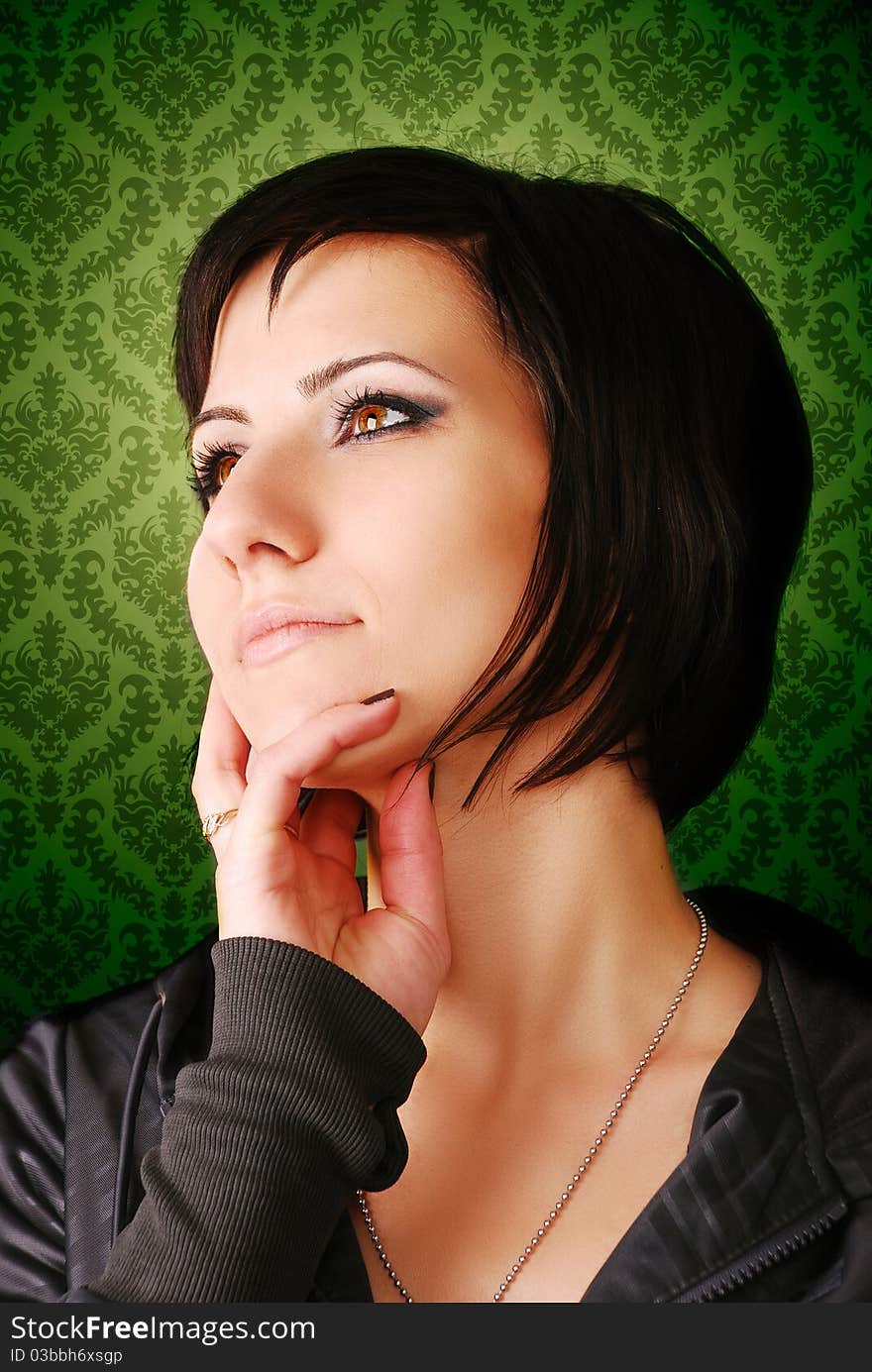 Portrait of a young girl on green background