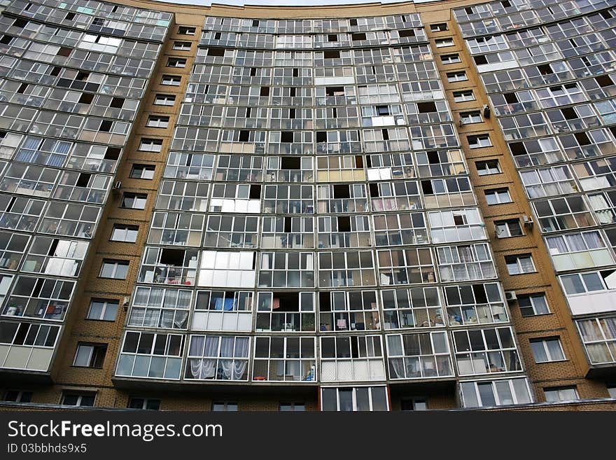 An apartment high-rise building of yellow brick. An apartment high-rise building of yellow brick