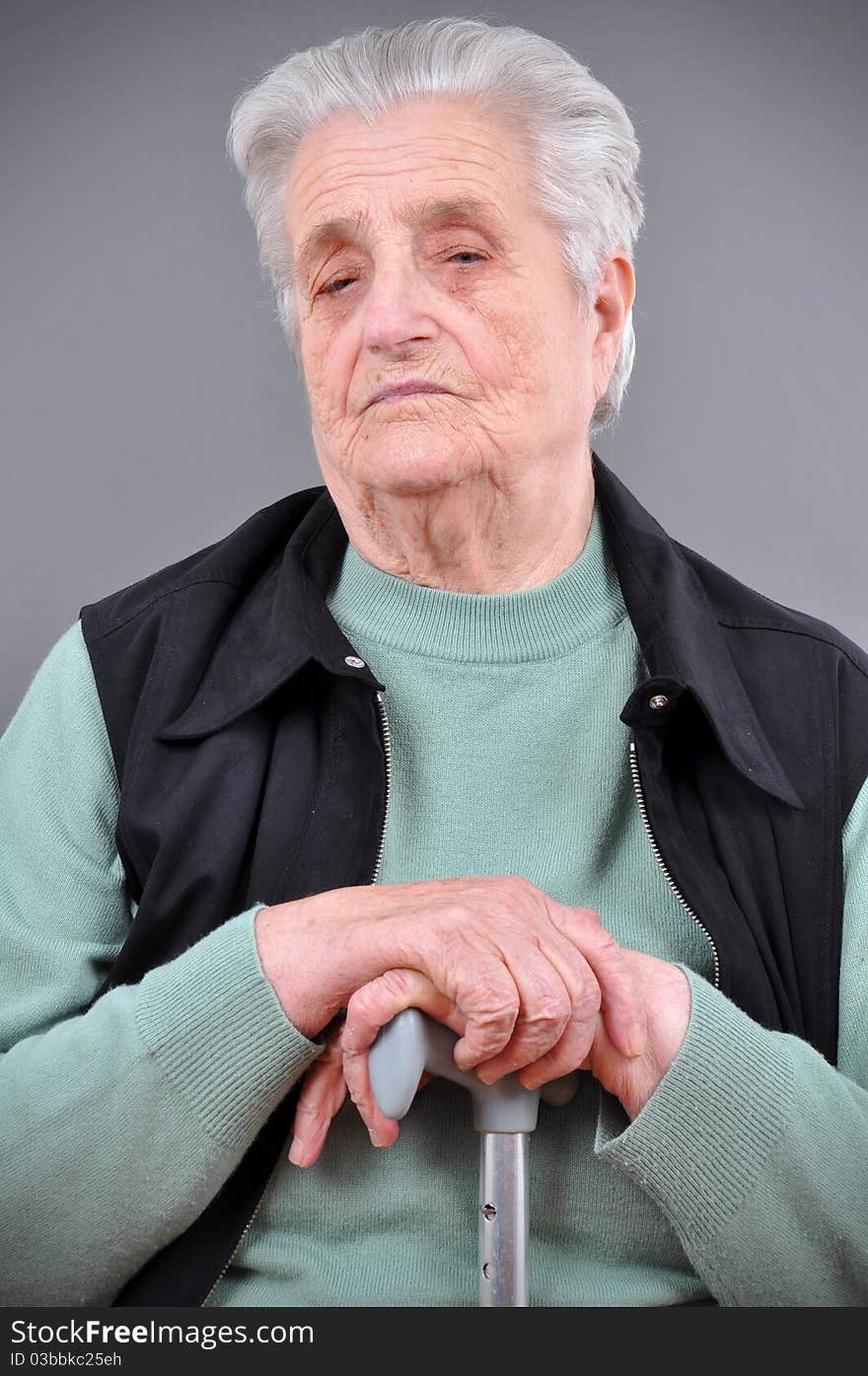 Portrait of grey haired woman looking at camera