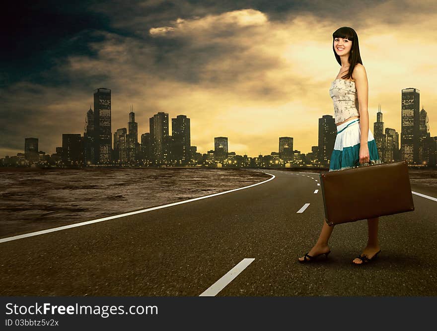 Young woman waiting on the road with her vintage baggage. Young woman waiting on the road with her vintage baggage