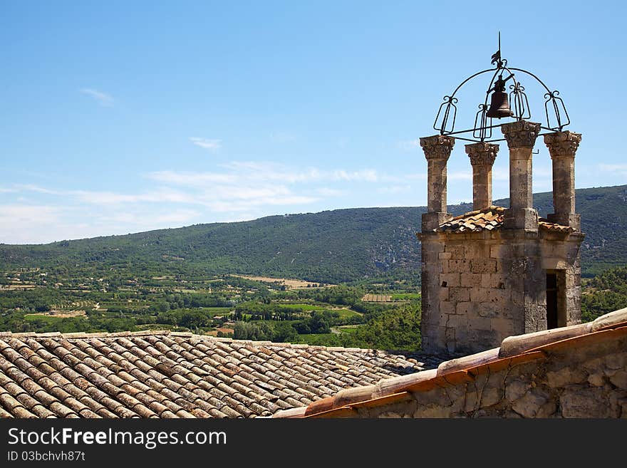 A view across some rooftops to the Luberon, France. A view across some rooftops to the Luberon, France