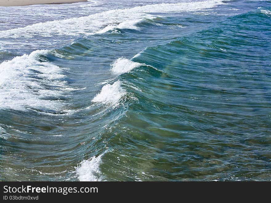 One after another wave rolled on the sand. One after another wave rolled on the sand