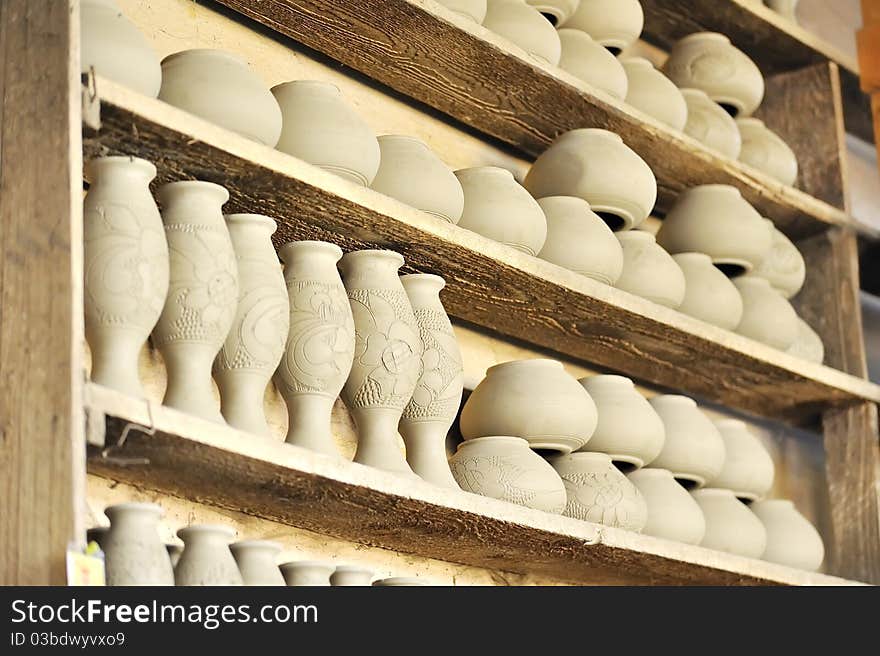 Drying ceramic vase inside of workshop