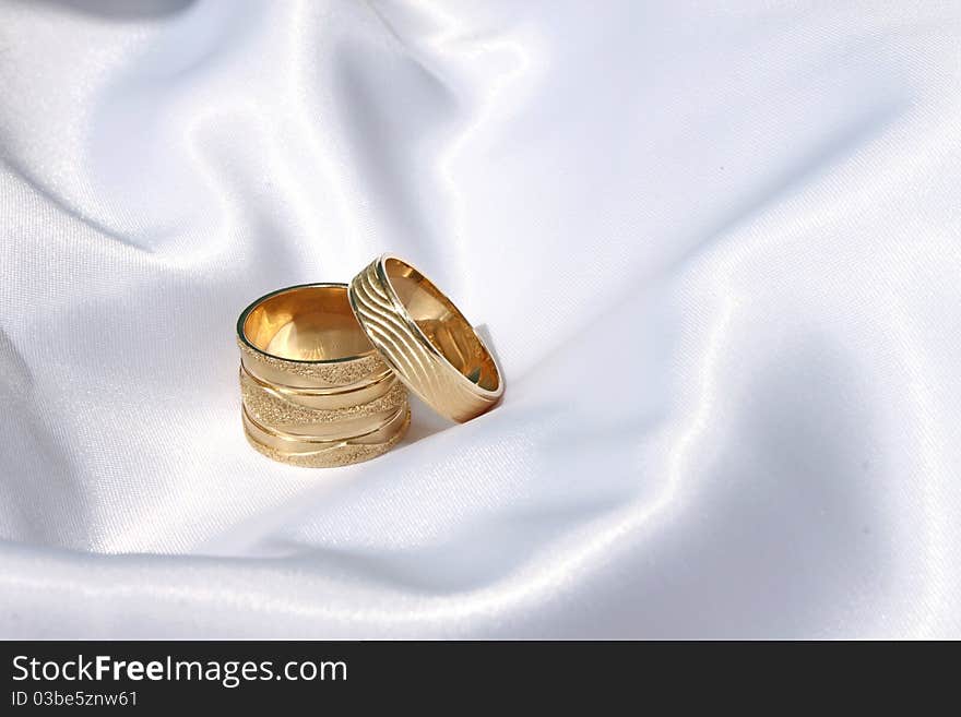 Wedding rings on the satin/silk surface. Wedding rings on the satin/silk surface