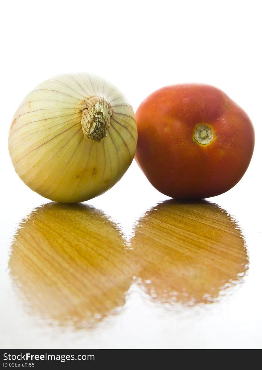 Onion and tomato with surface of wood table