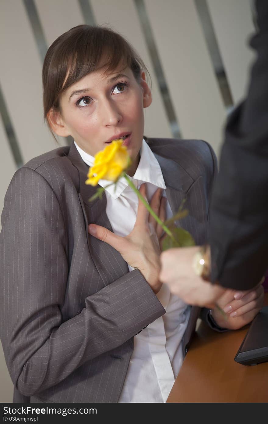 Man giving rose as a gift to a female office worker