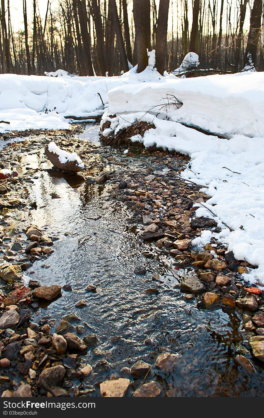 River in winter forest under snow