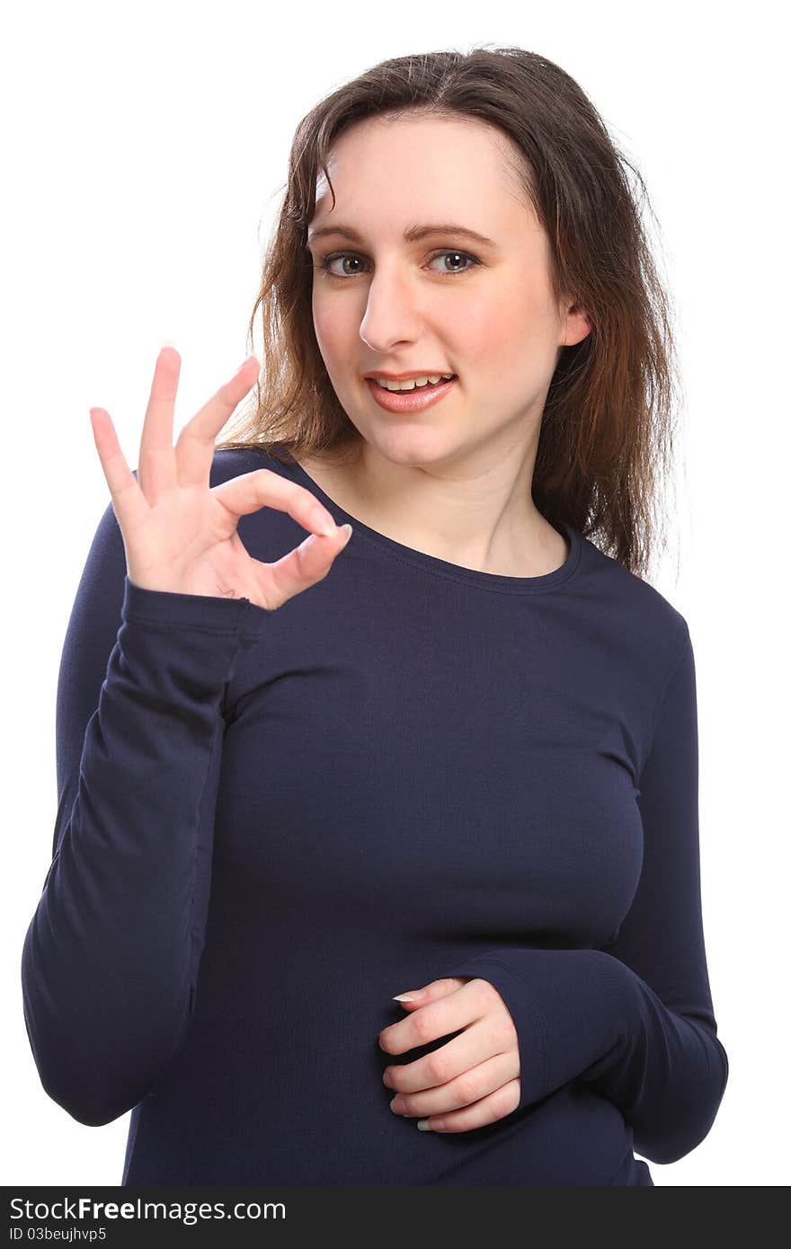 Beautiful happy young girl gives positive okay hand sign, wearing a navy blue long sleeve t-shirt. Beautiful happy young girl gives positive okay hand sign, wearing a navy blue long sleeve t-shirt.