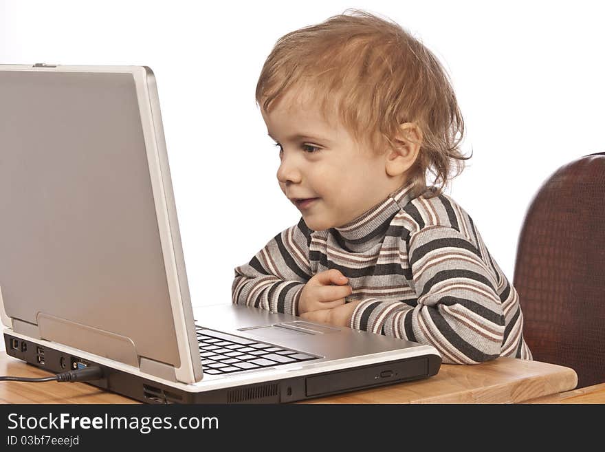 Little child and laptop. Isolated on white background