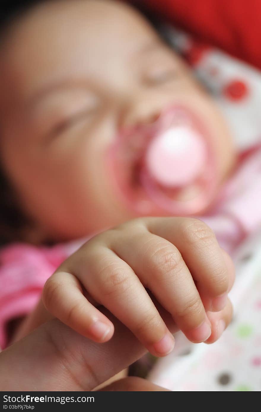 Close up of a baby hand with blurred baby background. Close up of a baby hand with blurred baby background