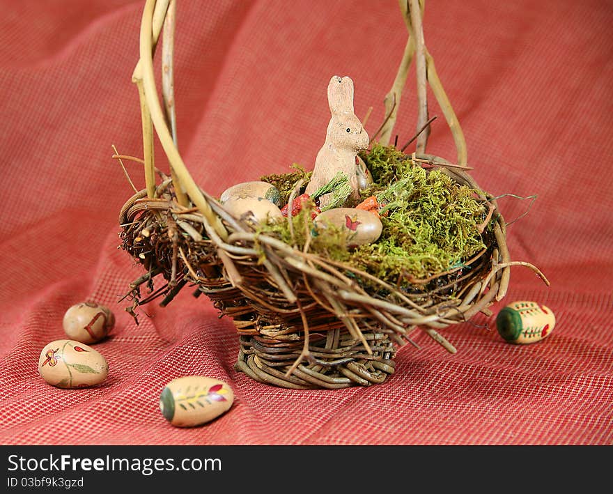 Vintage Easter basket with wooden bunny and hand-painted eggs with Americana color scheme. Vintage Easter basket with wooden bunny and hand-painted eggs with Americana color scheme.