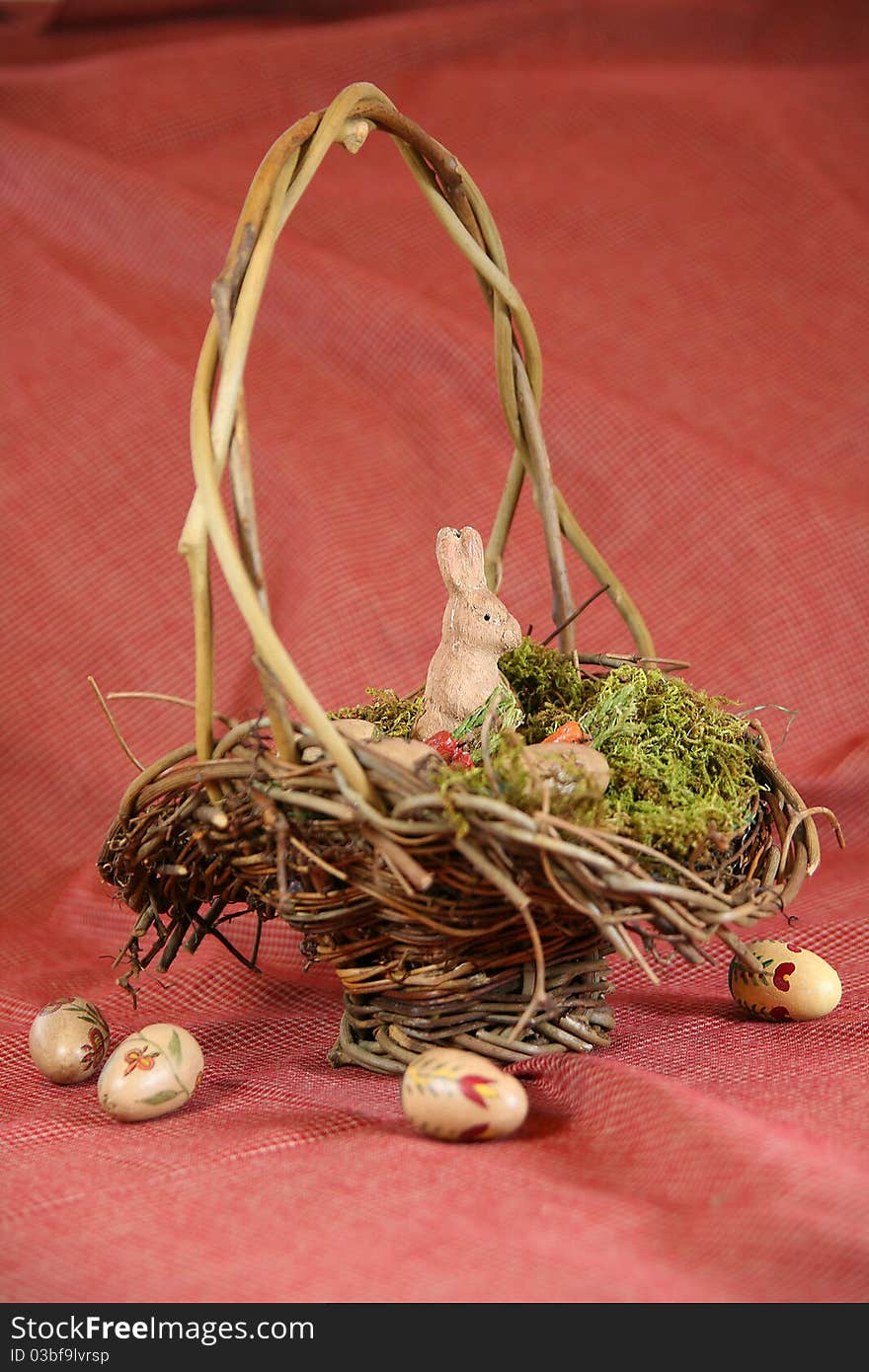 Vintage Easter basket with wooden bunny and hand-painted eggs with Americana color scheme. Vintage Easter basket with wooden bunny and hand-painted eggs with Americana color scheme.