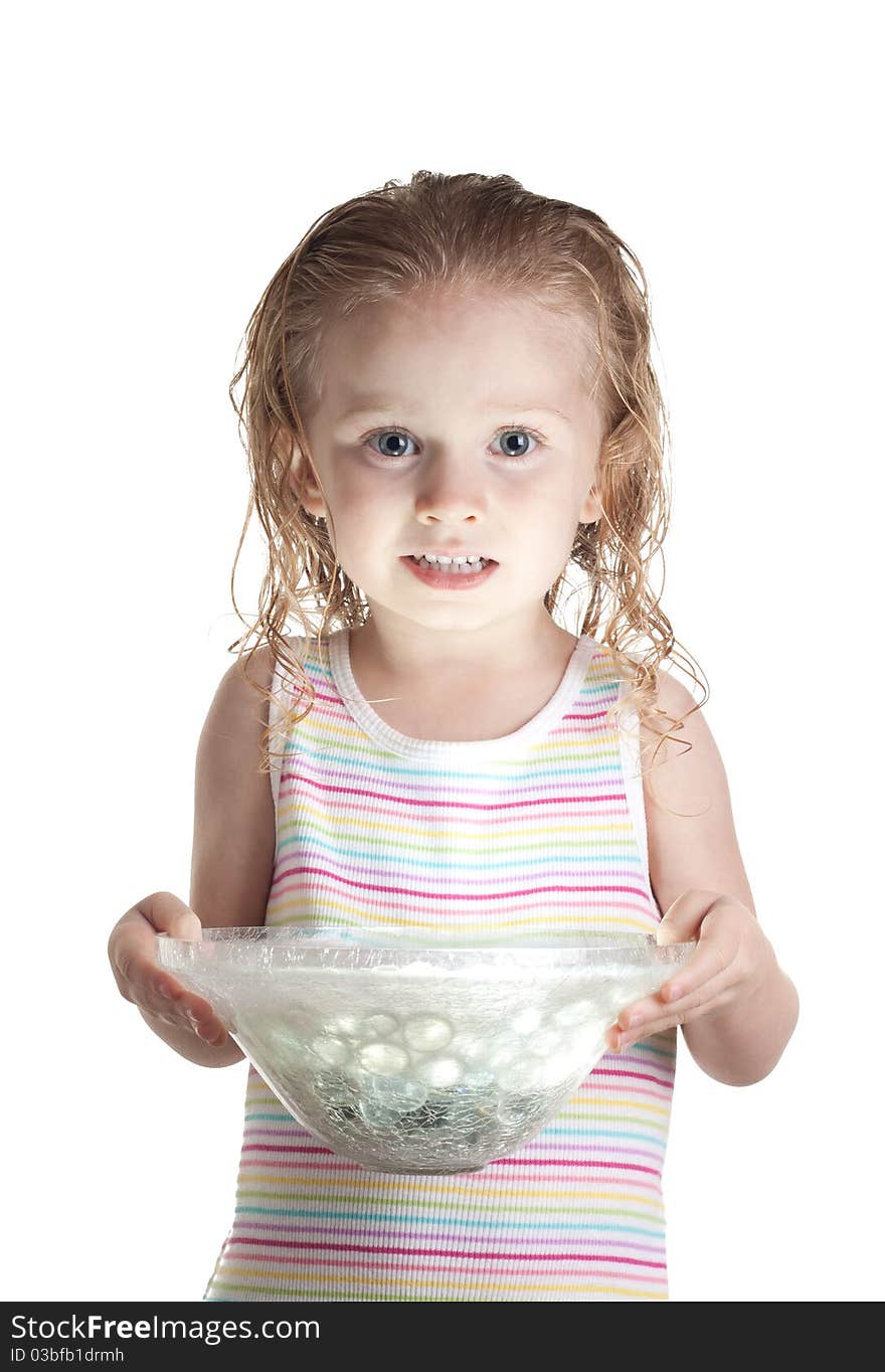 A nervous girl holding a glass bowl. The bowl has a ball of light inside of it. The light is glowing onto her face.