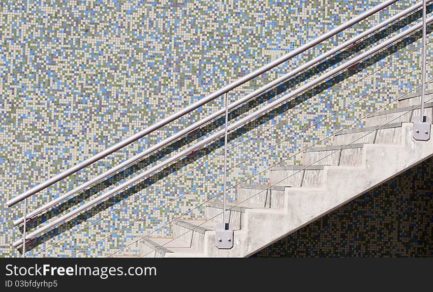 Modern external Staircase and a colorful mosaic wall.