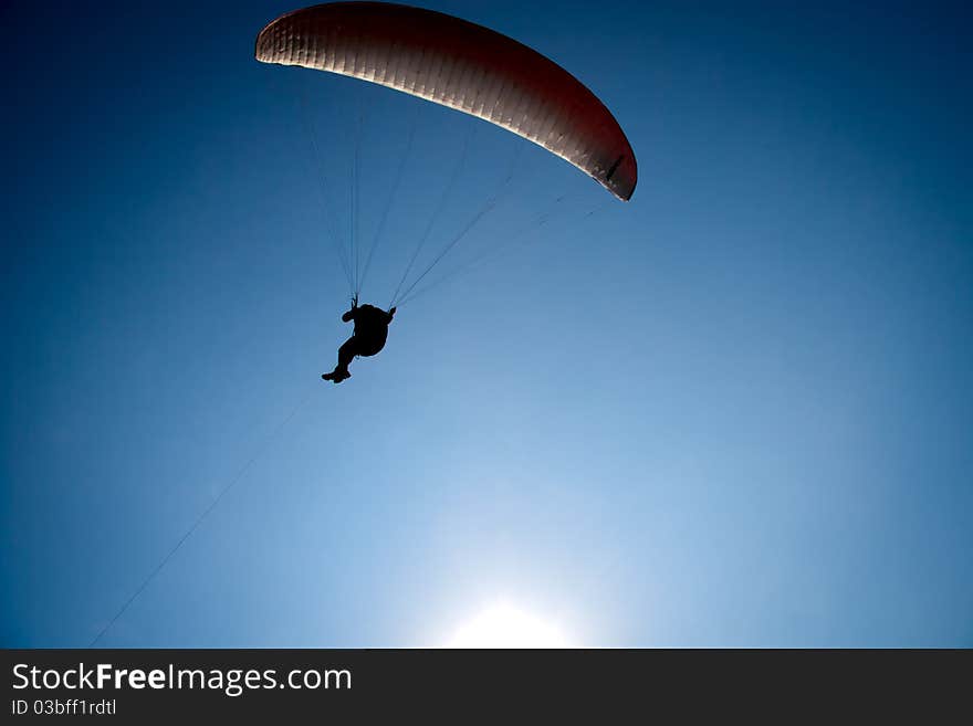 Parachutist flight against the blue sky