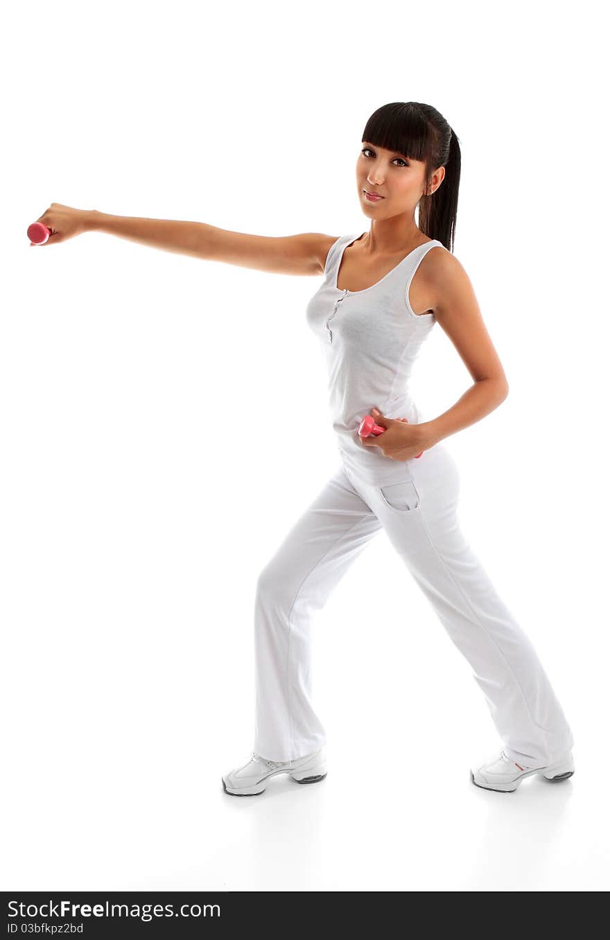 A beautiful young woman in sportswear and using hand weights during exercise workout. A beautiful young woman in sportswear and using hand weights during exercise workout.