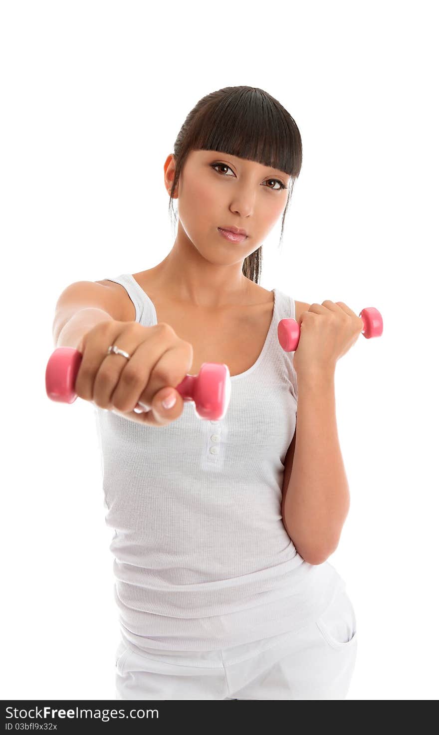 A fit and healthy young woman exercising with hand weights. White background. A fit and healthy young woman exercising with hand weights. White background.