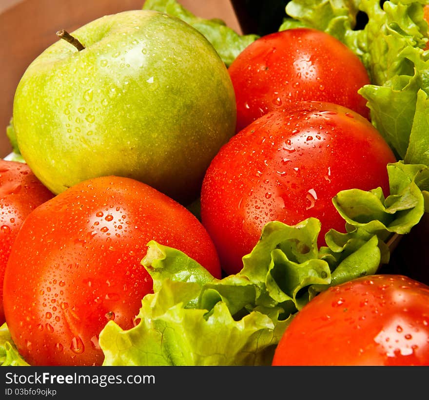 Tomatoes with fresh salad and a green apple. Tomatoes with fresh salad and a green apple