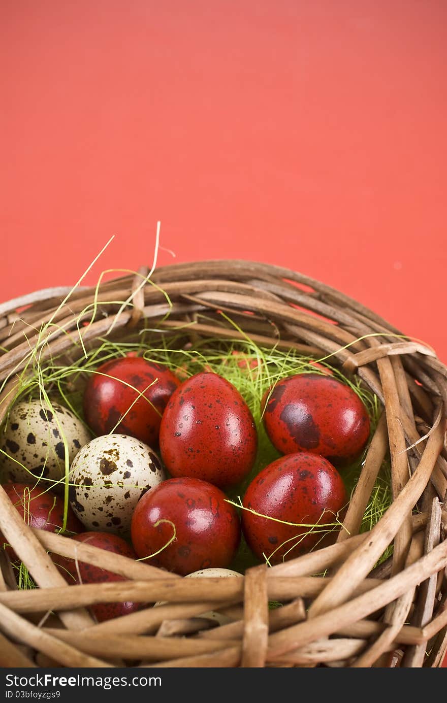 Easter eggs in basket on red background