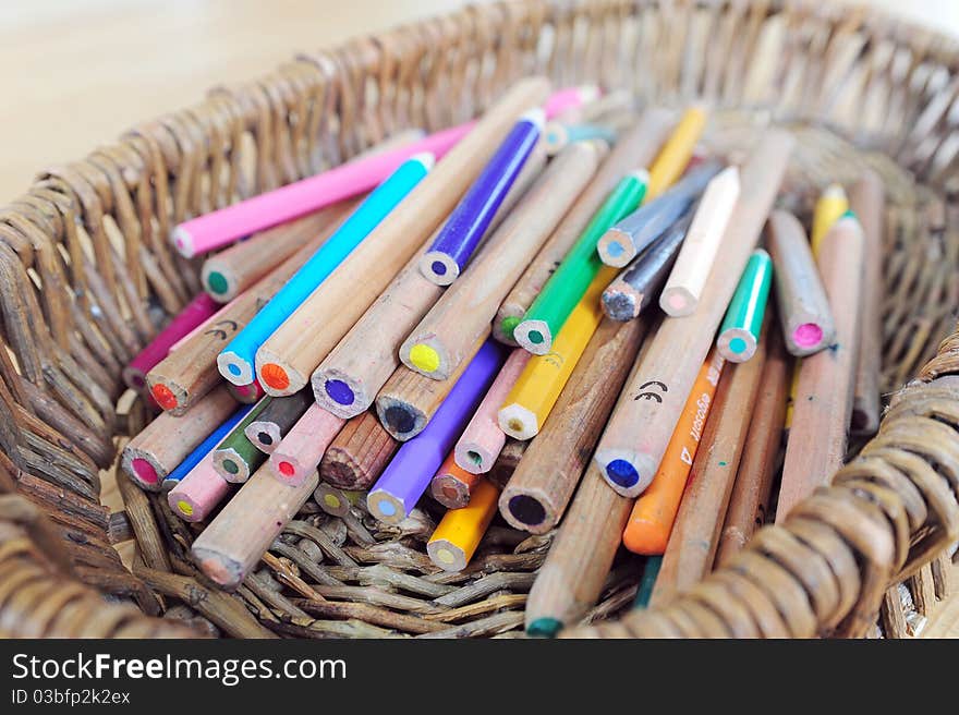 A heap of colour pencils in a basket. A heap of colour pencils in a basket