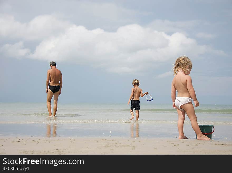 Father and kids on beach