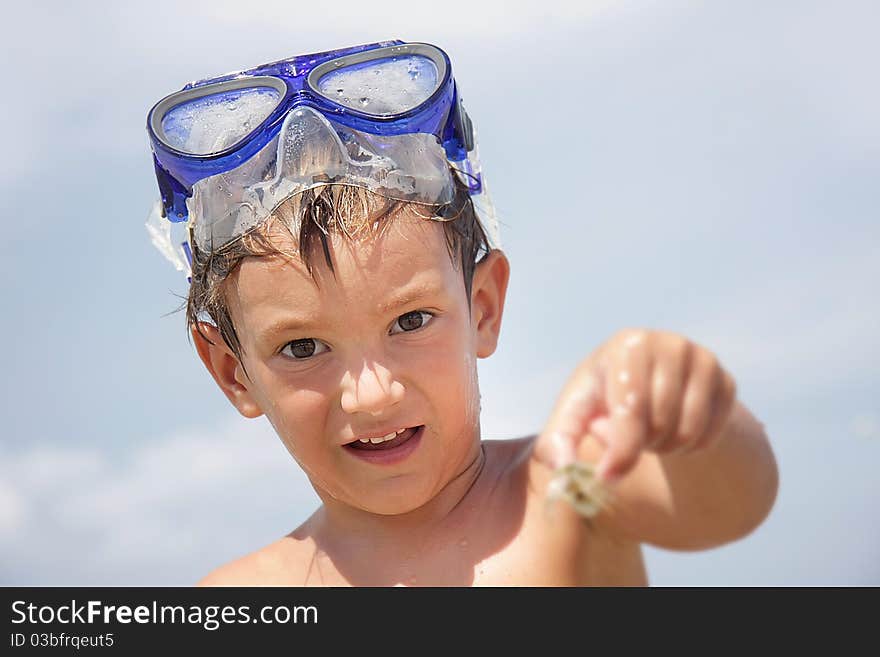 Boy in diving mask on sea background