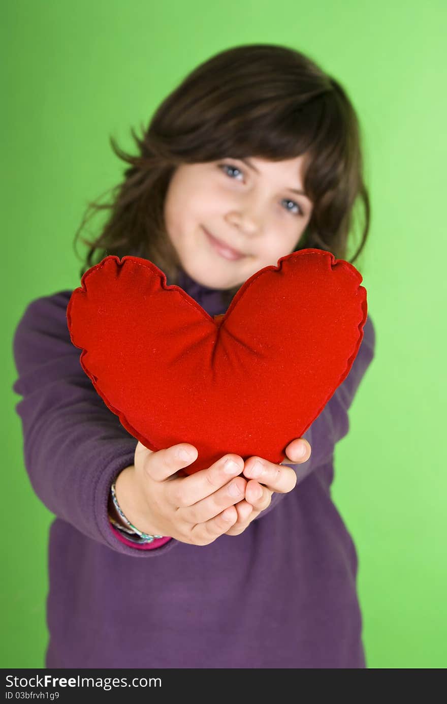 Happy little girl with red valentines heart