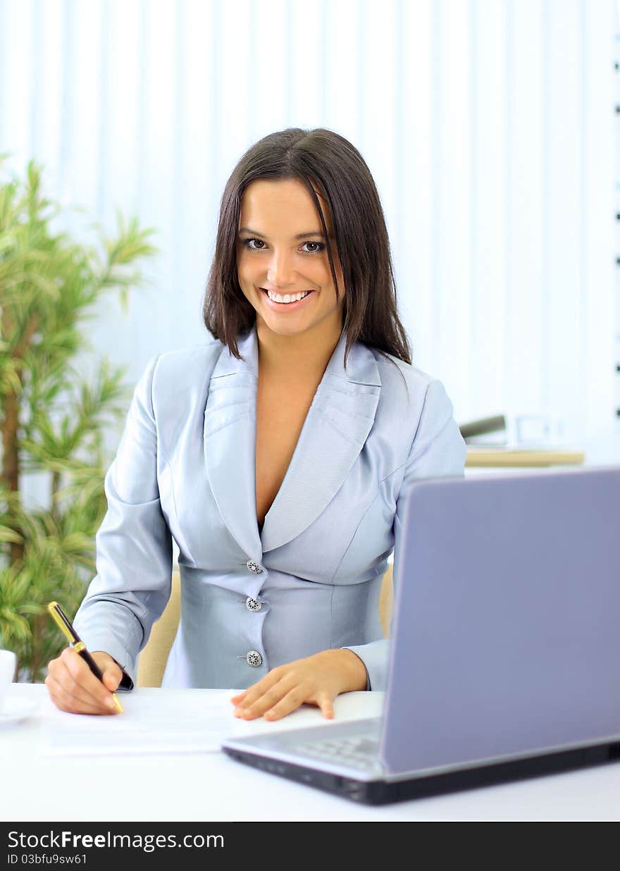 Young happy smiling businesswoman working at office