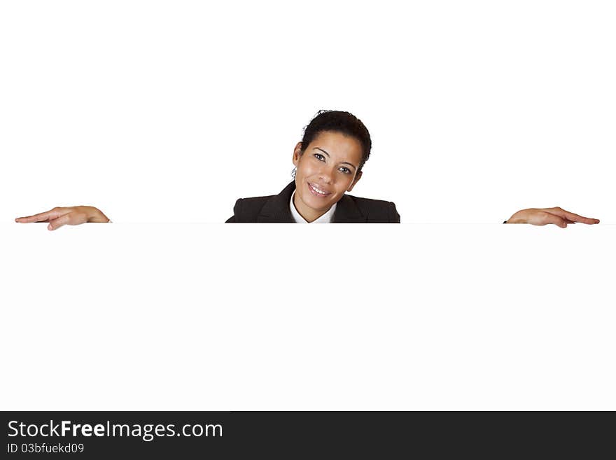 Young happy woman leans on blank billboard. Isolated on white background.