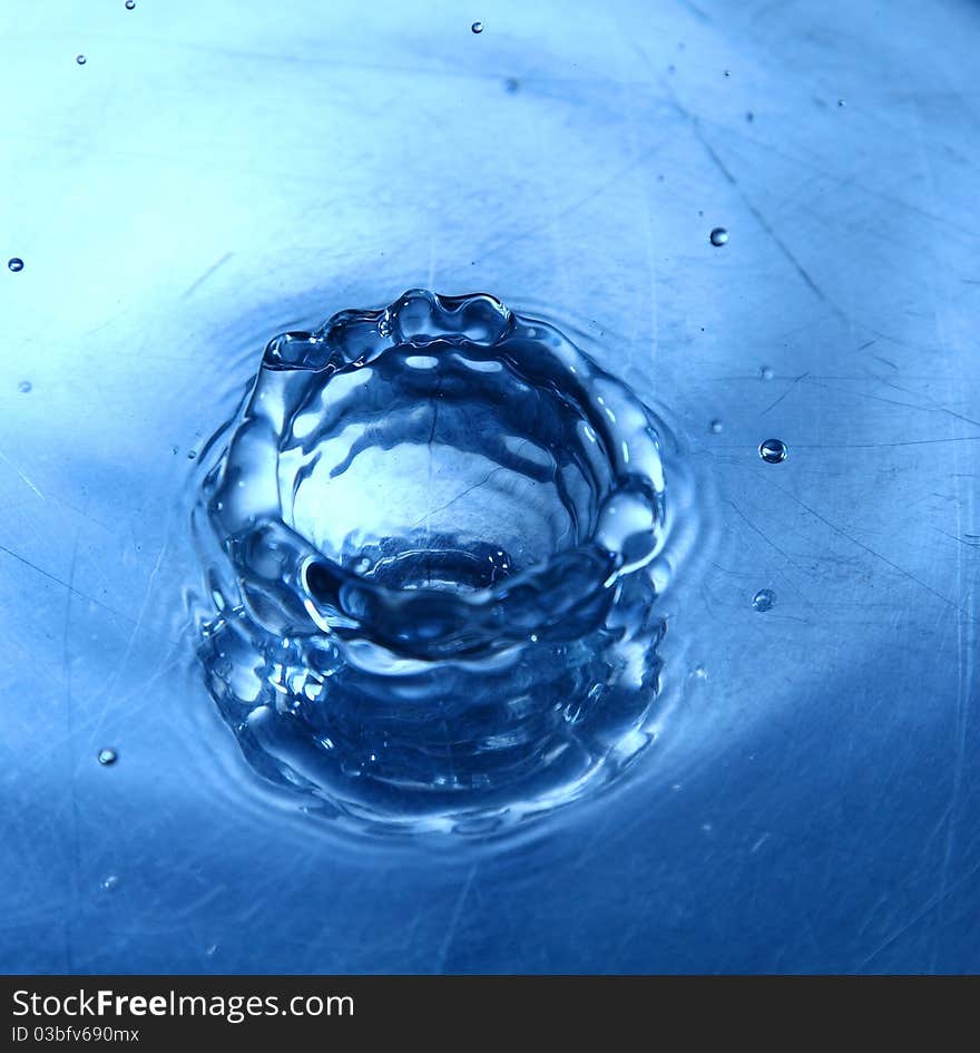 A water droplet in blue toned. A water droplet in blue toned.