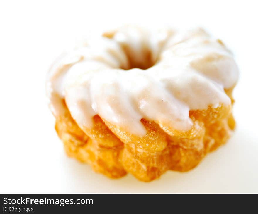 Cruller with icing isolated on white studio background