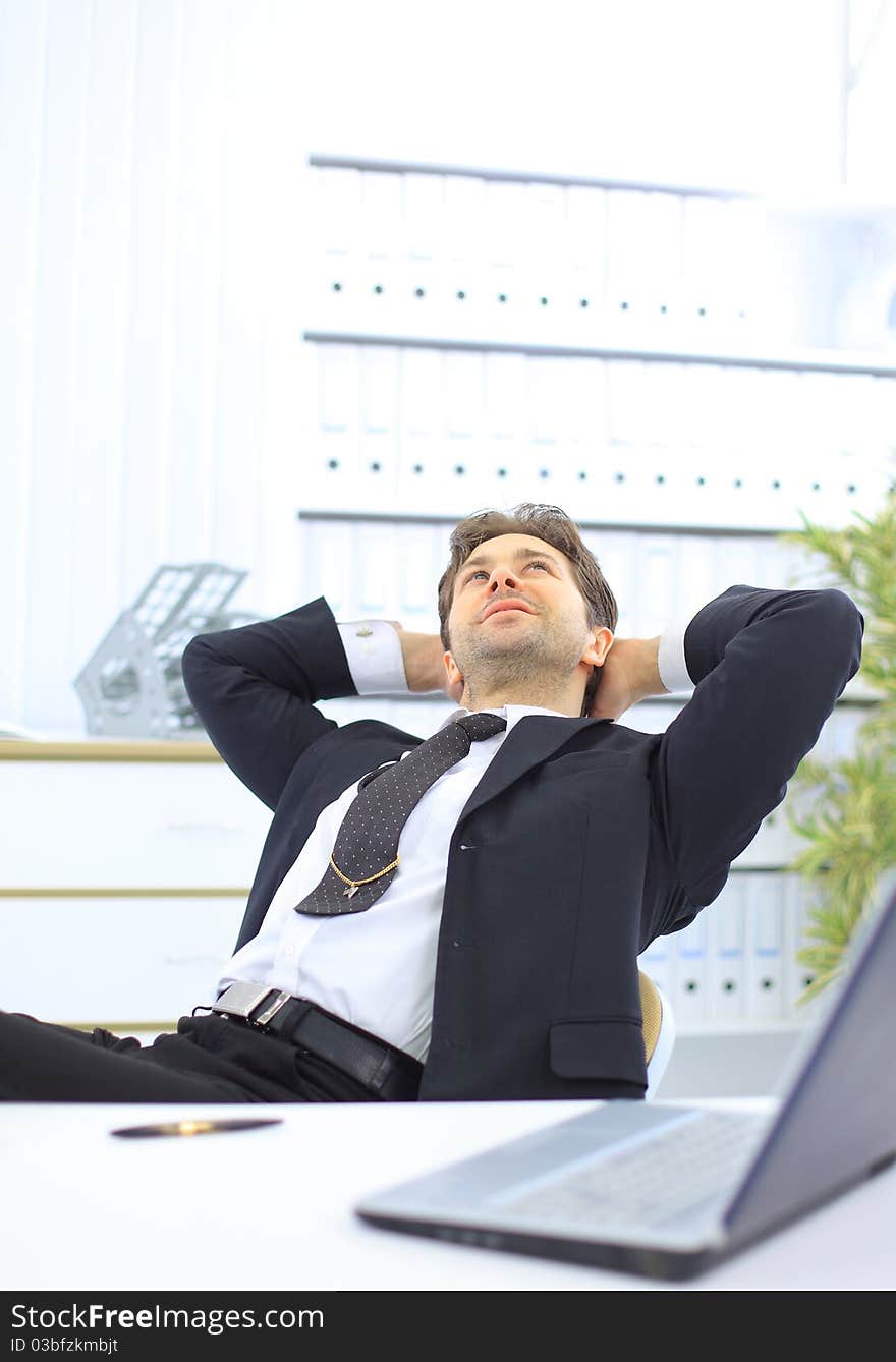 Portrait of happy smiling businessman at office