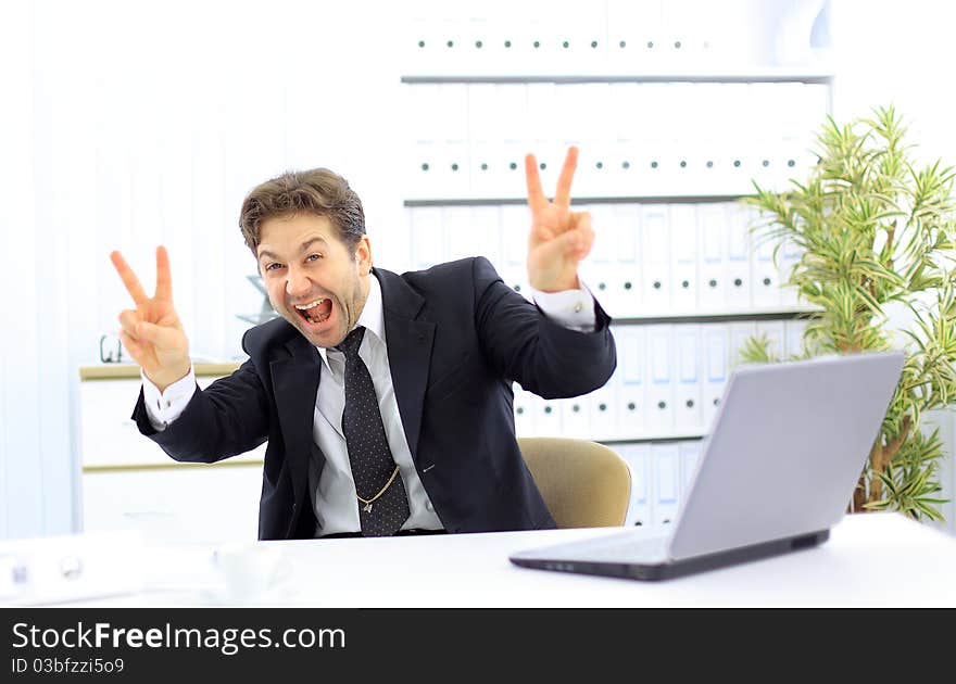 Portrait of young business man with a laptop