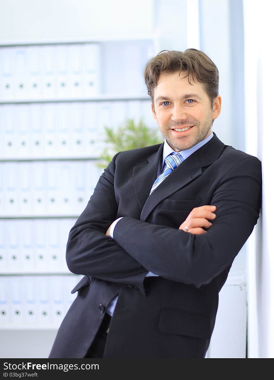 Young businessman standing in office