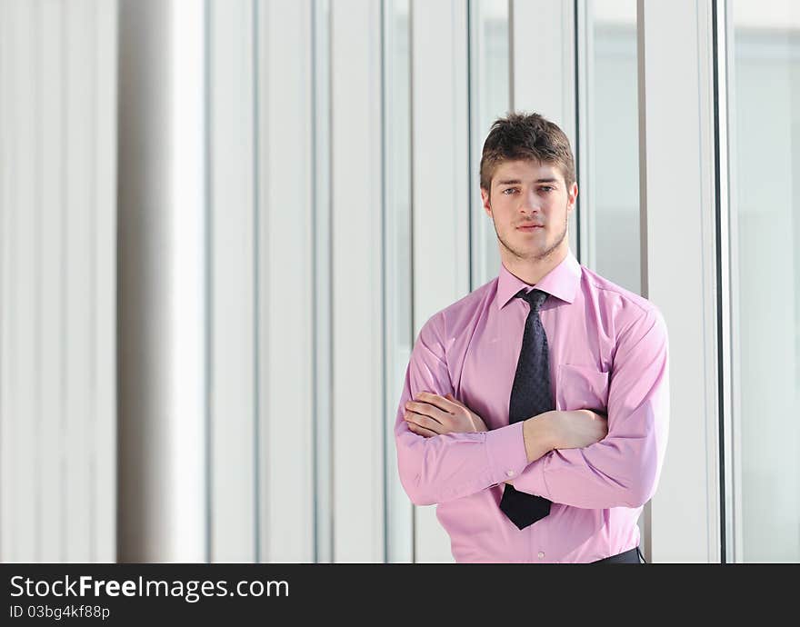 Young business man lawyer with laptop alone in big bright   conference room. Young business man lawyer with laptop alone in big bright   conference room