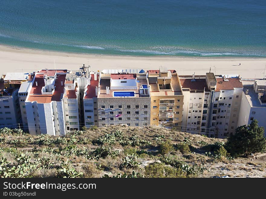 Buildings by beach and sea