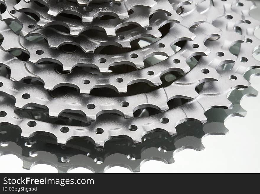 Close up macro shot of gear cogs and teeth on a reflective background. Close up macro shot of gear cogs and teeth on a reflective background